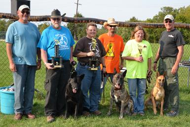 Cheryl Carlson & her Dutch Shepherd �Becker� winning the MI K-9 Challenge Protection Dog Tournament in 2012.  This picture is more amazing as all the dogs that placed in the Advanced Division (1st-Dutch Shepherd �Becker�, 2nd-German Shepherd �Paladin� & 3rd-Belgian Malinois �Elphaba�) were bred by Cher Car Kennels!